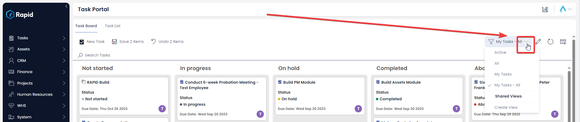 A screenshot demonstrating the location of the Task Board view button. This is a drop-down menu button that will open a series of other views to choose from, as well as an option at the bottom that reads &quot;Create View&quot;. In this example, the button has the title &quot;My Tasks - All&quot;, as this is the current view selected. The button also has an icon of a filter. The screenshot is annotated with a red arrow and red box to highlight the location of the view button.